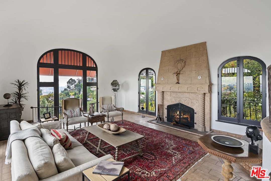 8142 Laurel View Drive Los Angeles, CA 90069 - Photo 10 of 41 a living room with furniture a window and a fireplace