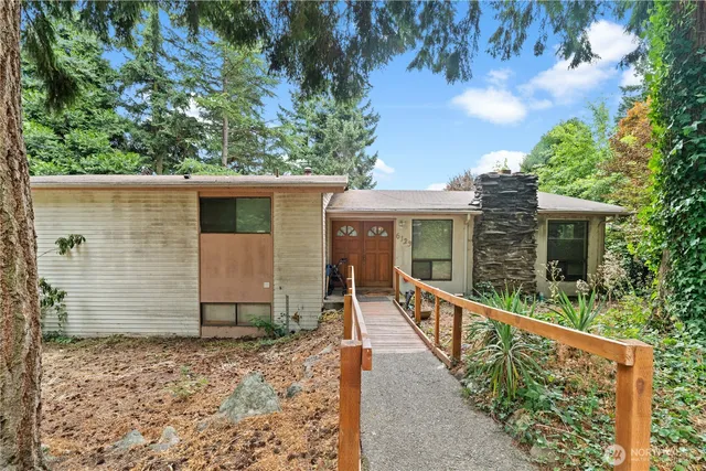 an outdoor view of house with trees around