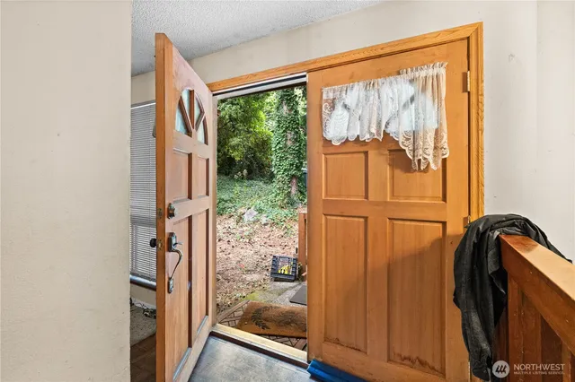 a living room with furniture a rug and gym equipment