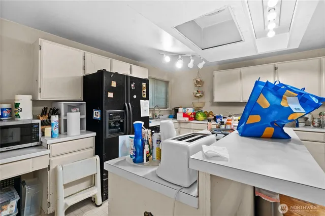 a view of a dining room with furniture and a chandelier