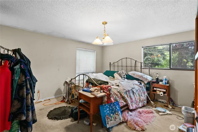 a bedroom with furniture and a flat screen tv