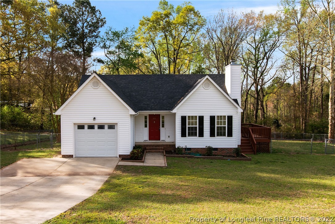 a front view of a house with a yard garage and outdoor seating