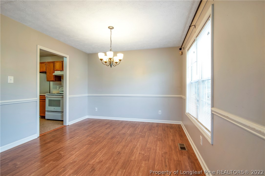 205 Rye Lane Raeford, NC 28376 - Photo 11 of 38 wooden floor in an empty room with a window