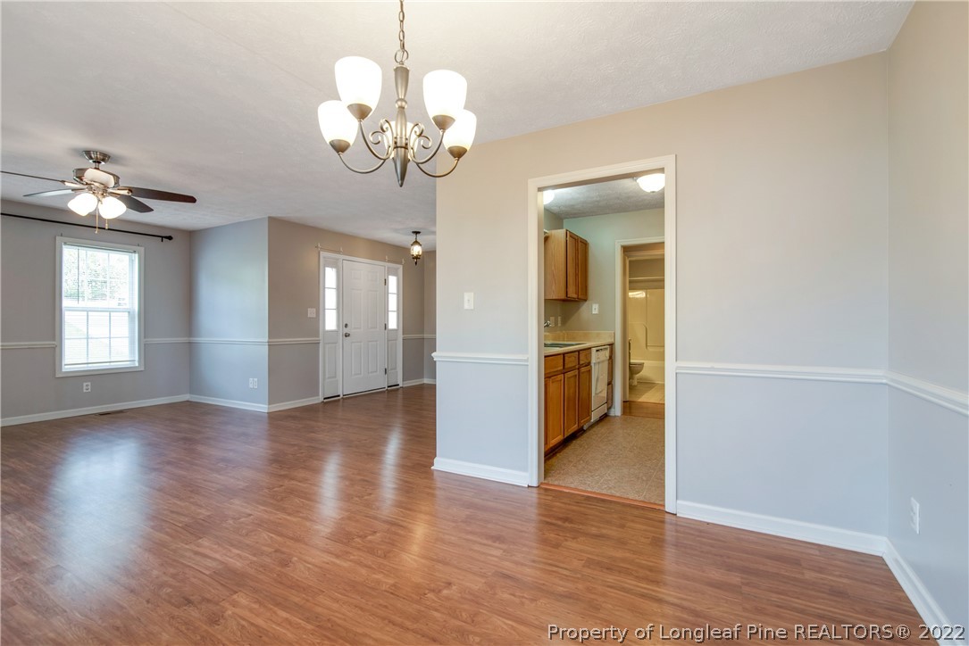 205 Rye Lane Raeford, NC 28376 - Photo 12 of 38 a view of a livingroom with a chandelier fan and windows