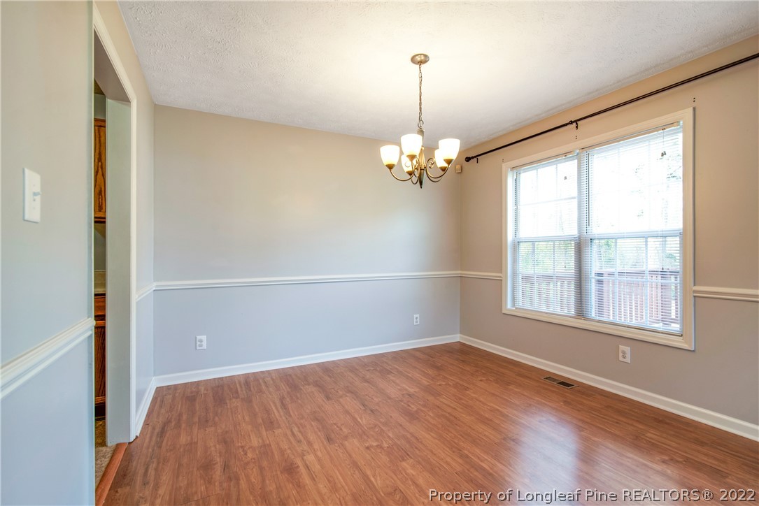 205 Rye Lane Raeford, NC 28376 - Photo 14 of 38 wooden floor in an empty room with a window