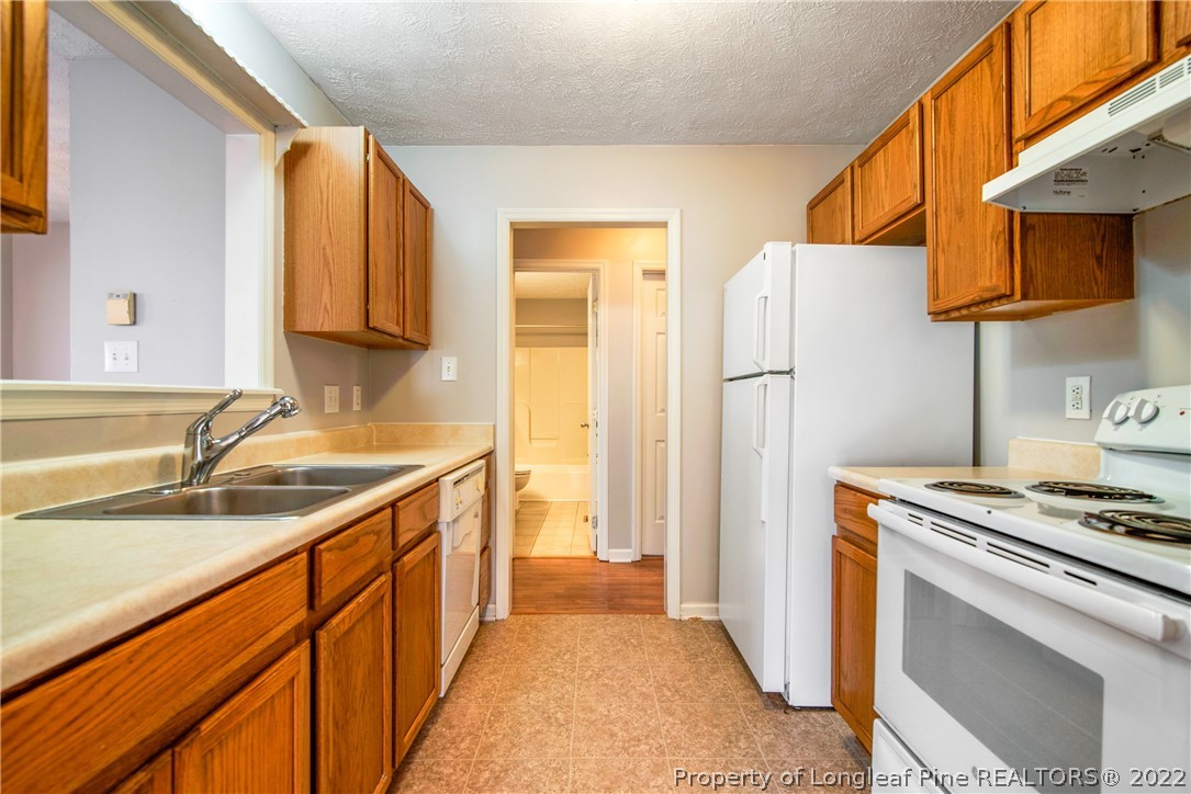 205 Rye Lane Raeford, NC 28376 - Photo 15 of 38 a kitchen with a sink stove and refrigerator