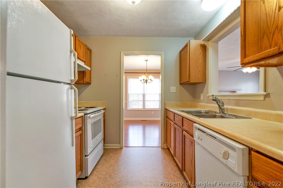 205 Rye Lane Raeford, NC 28376 - Photo 16 of 38 a kitchen with stainless steel appliances granite countertop a sink and a refrigerator
