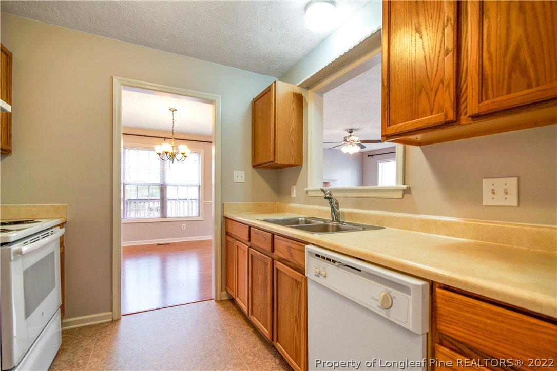 205 Rye Lane Raeford, NC 28376 - Photo 17 of 38 a kitchen with a sink stove and cabinets