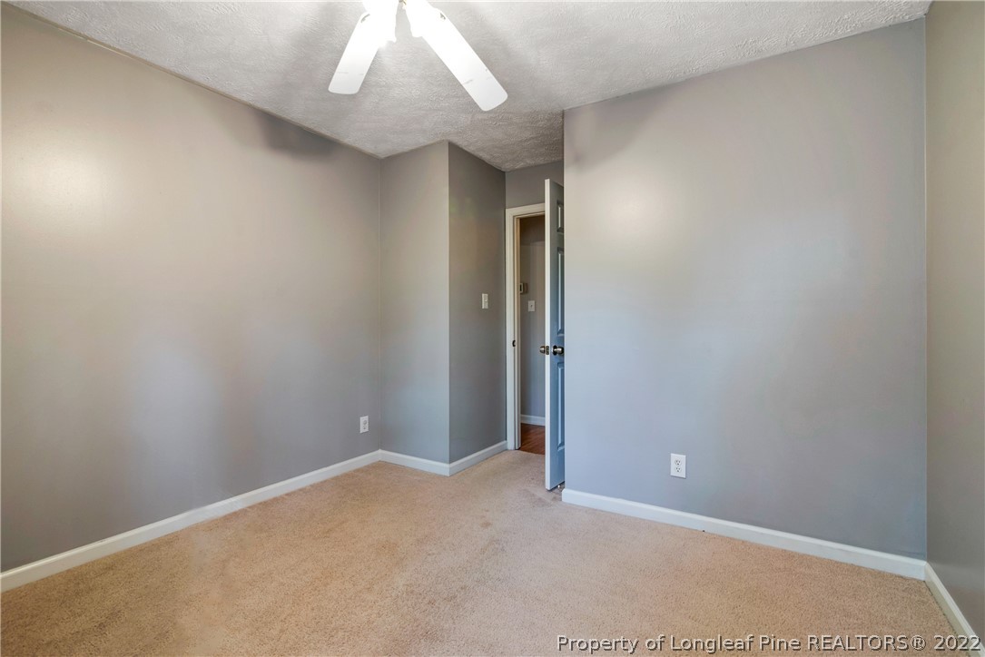 205 Rye Lane Raeford, NC 28376 - Photo 27 of 38 an empty room with a chandelier fan
