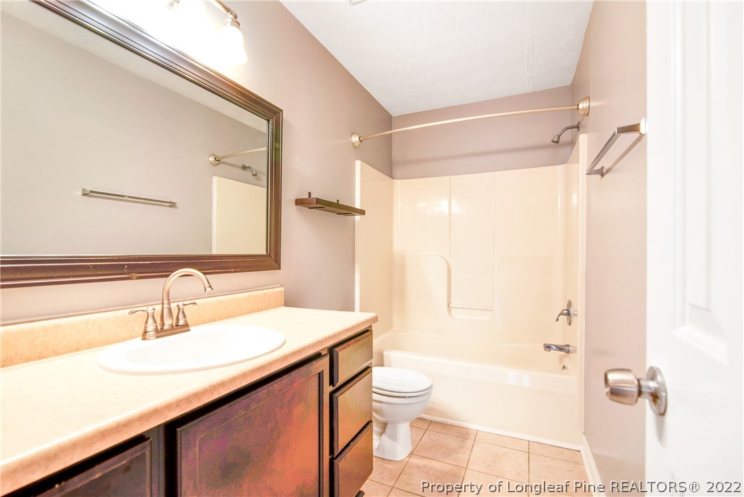 205 Rye Lane Raeford, NC 28376 - Photo 29 of 38 a bathroom with a sink a toilet and shower