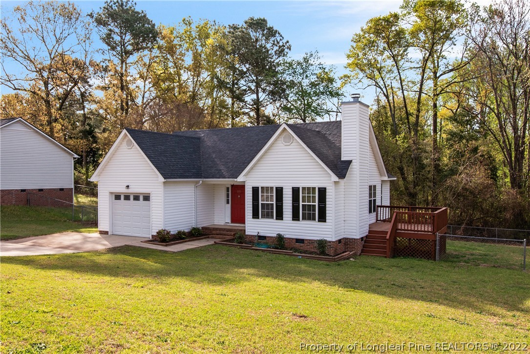 205 Rye Lane Raeford, NC 28376 - Photo 3 of 38 a view of a house with a yard table and chairs