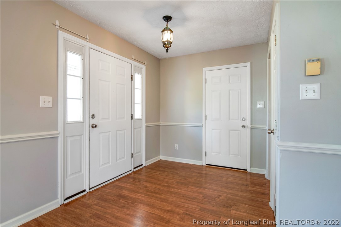 205 Rye Lane Raeford, NC 28376 - Photo 6 of 38 a view of empty room with wooden floor and fan