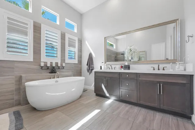 a view of a house with a patio and a yard