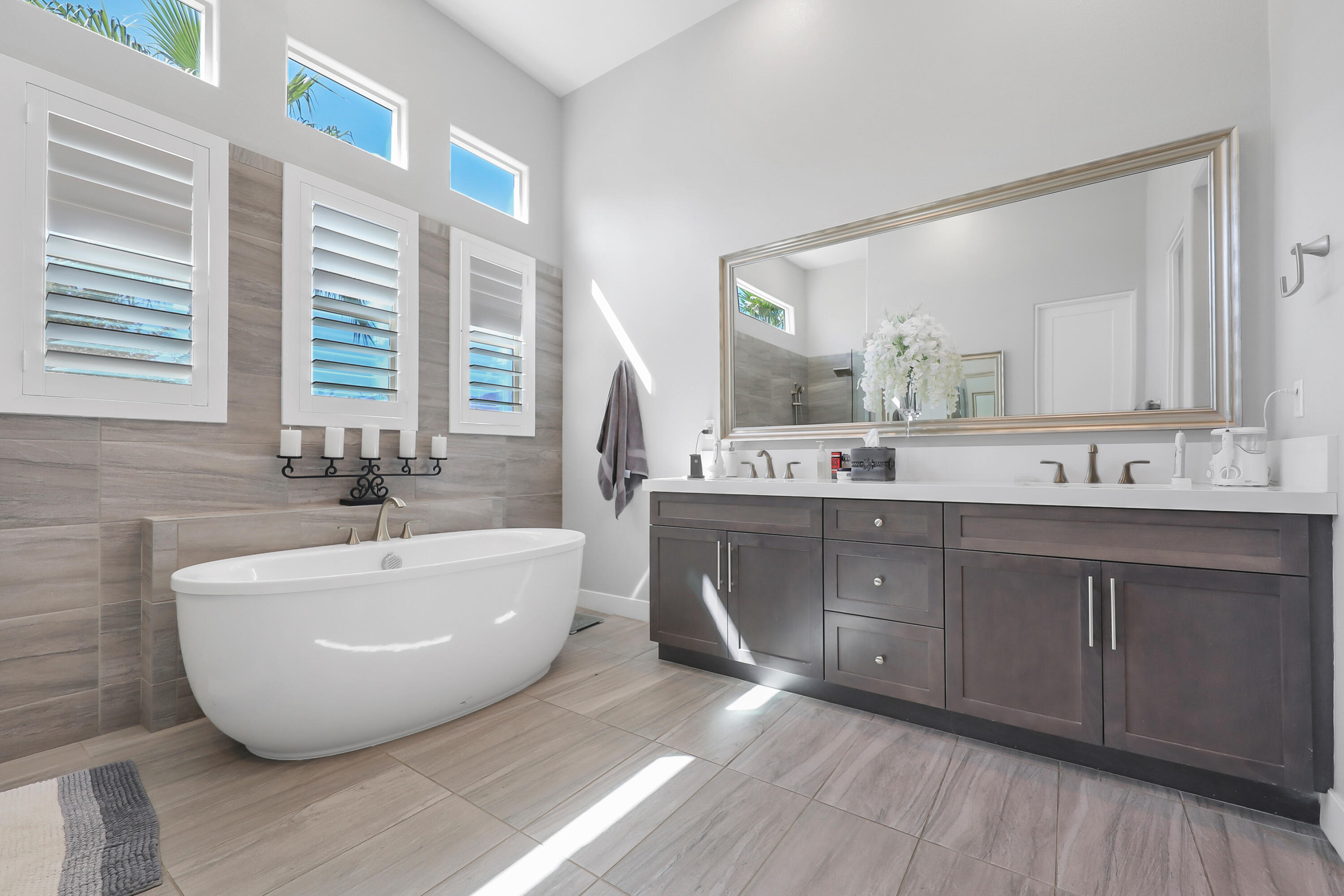 81-695 Thunder Gulch Way La Quinta, CA 92253 - Photo 16 of 51 a spacious bathroom with a double vanity sink a mirror and a bathtub