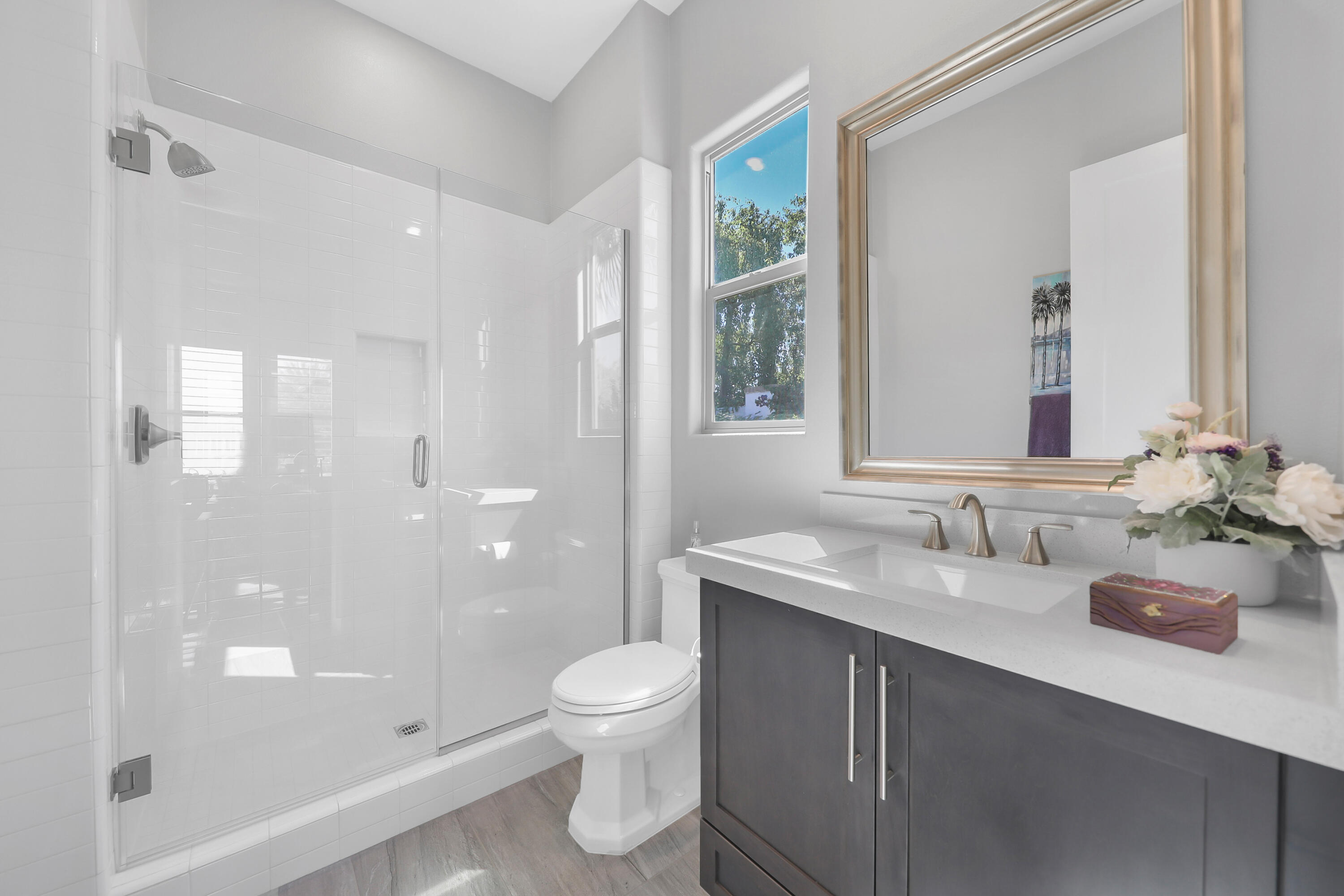 81-695 Thunder Gulch Way La Quinta, CA 92253 - Photo 18 of 51 a bathroom with a sink vanity granite toilet and shower
