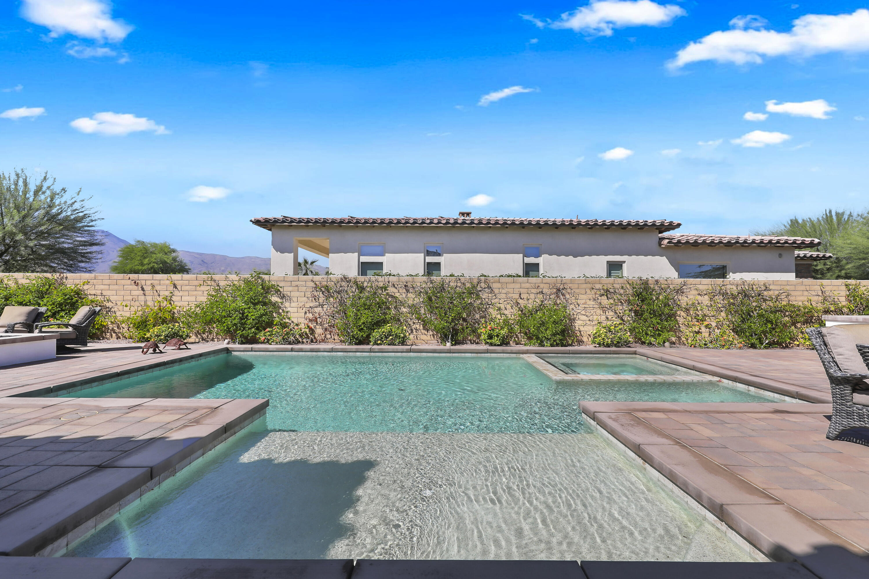81-695 Thunder Gulch Way La Quinta, CA 92253 - Photo 31 of 51 a view of a backyard with plants and lake view