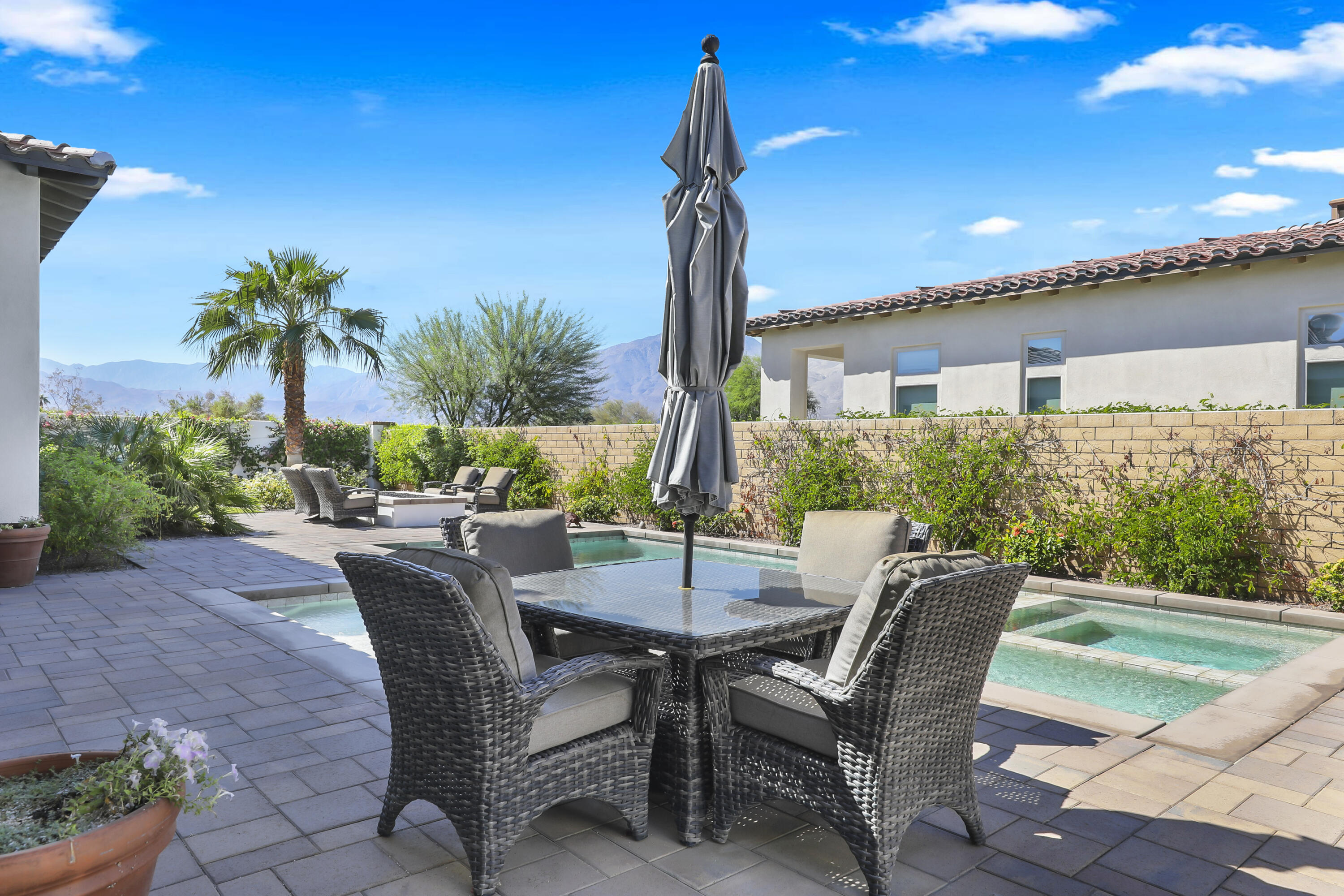 81-695 Thunder Gulch Way La Quinta, CA 92253 - Photo 35 of 51 a view of a patio with table and chairs and potted plants