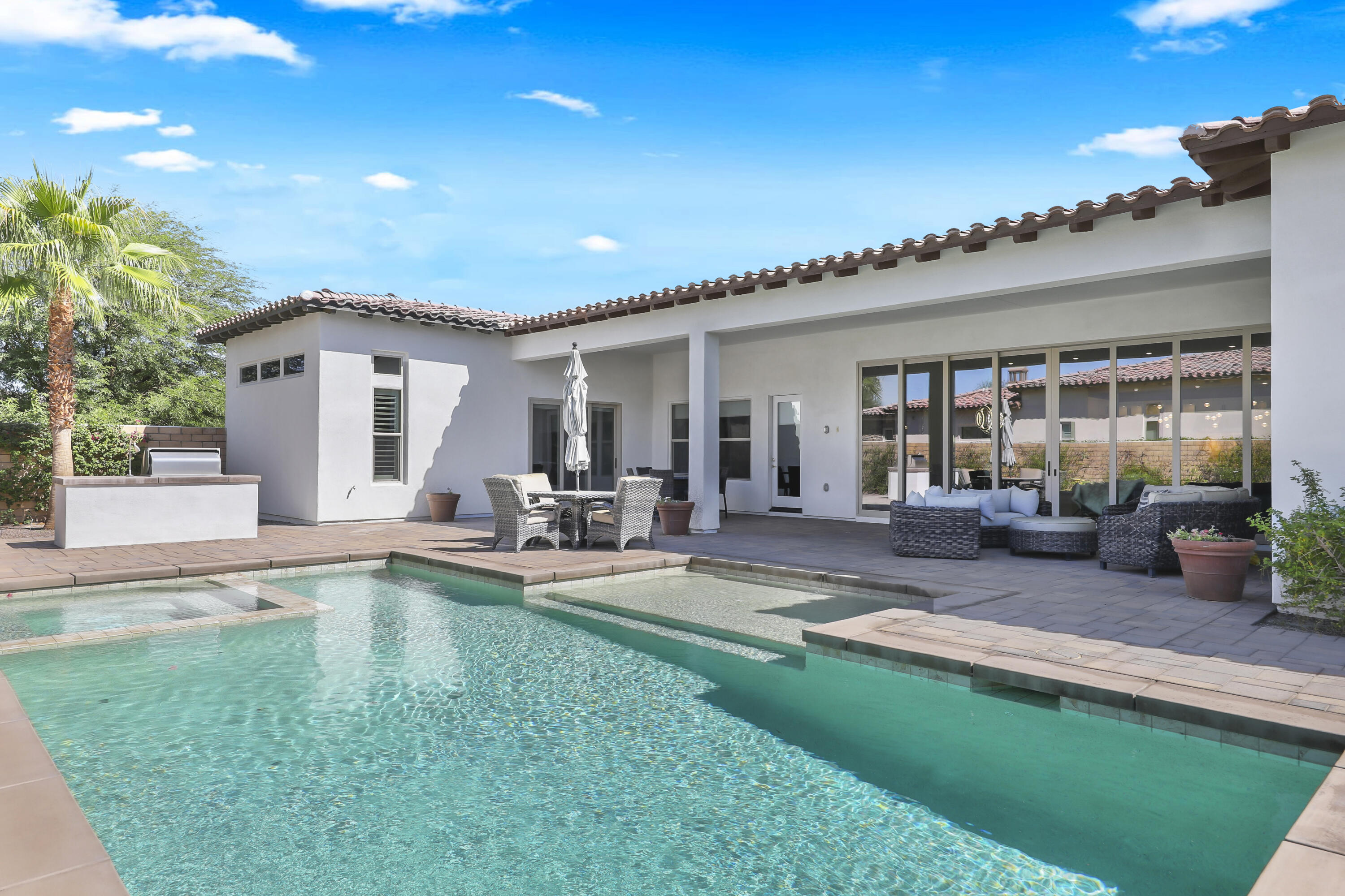 81-695 Thunder Gulch Way La Quinta, CA 92253 - Photo 39 of 51 a view of a house with a patio and a yard