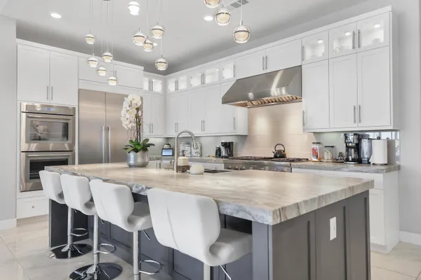 a bathroom with a sink vanity granite toilet and shower