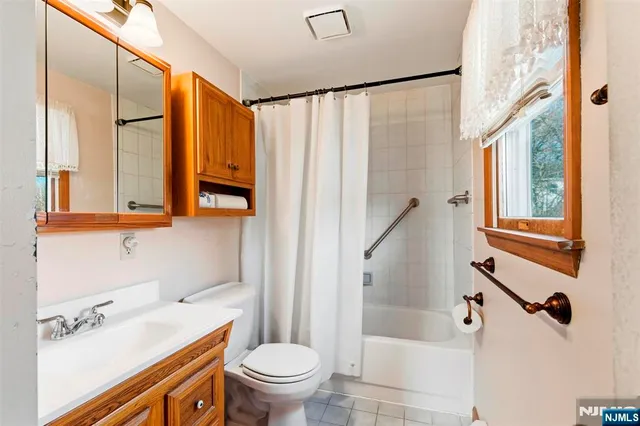a bathroom with a sink a toilet and a shower