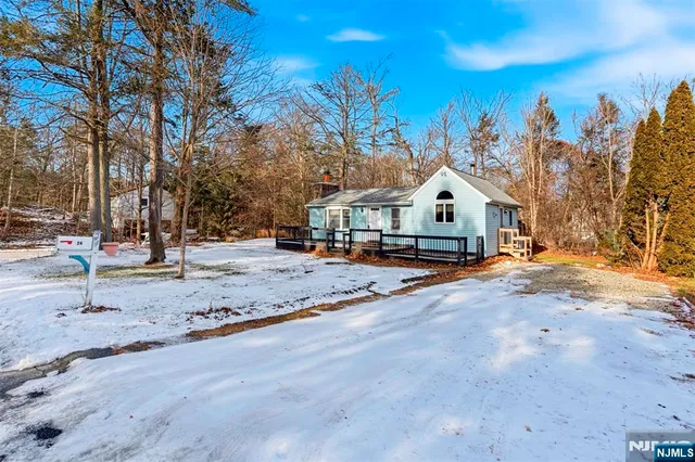 a view of house with tree in front of it