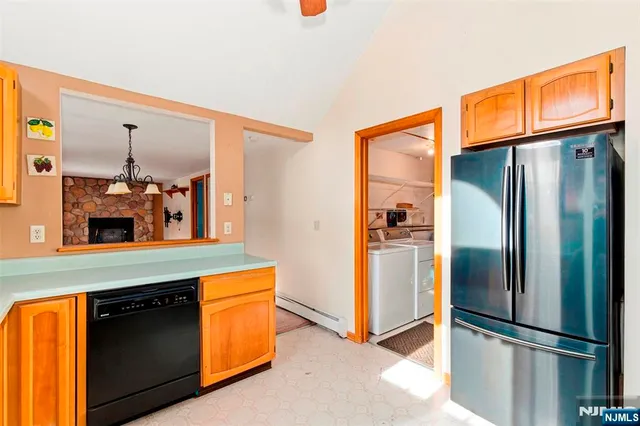 a kitchen with stainless steel appliances granite countertop a refrigerator and a sink