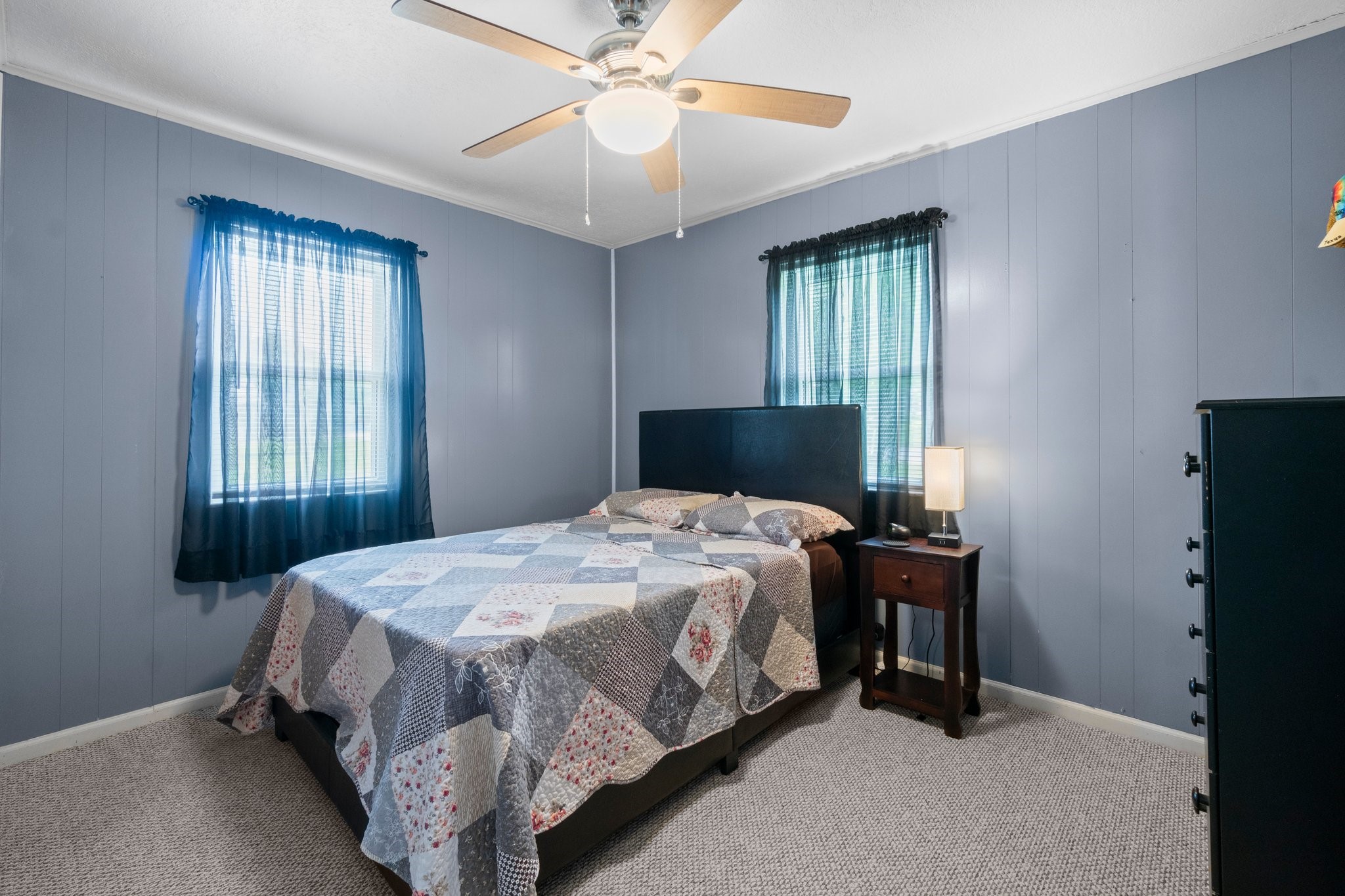 21 Clearview Point Blank, TX 77364 - Photo 22 of 43 a bedroom with a bed and a chandelier