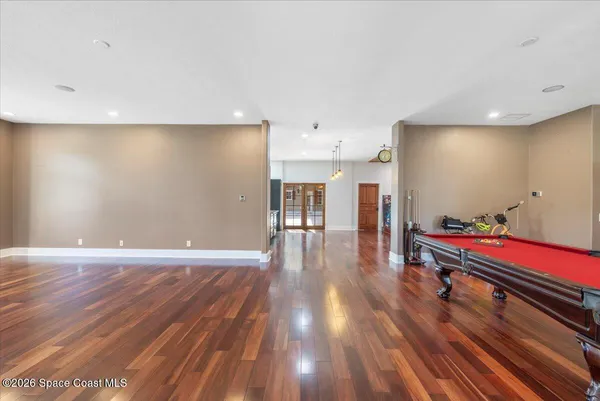a kitchen with stainless steel appliances granite countertop a refrigerator a stove and a wooden floors