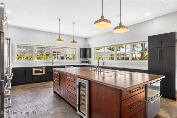 a kitchen with a sink a counter top space and stainless steel appliances