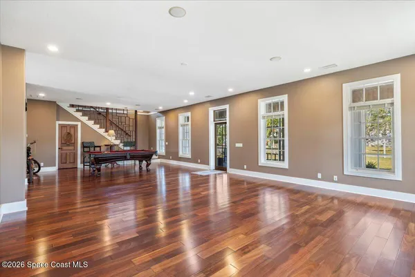 a view of a hallway with furniture and wooden floor