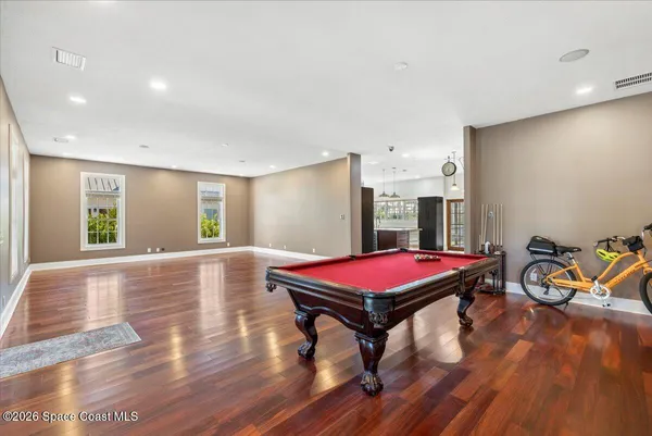 a large kitchen with stainless steel appliances granite countertop a sink and a refrigerator