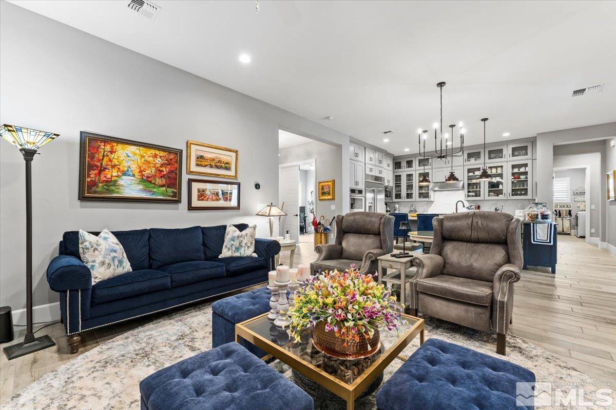 2166 Kate's Bridge Drive Reno, NV 89521 - Photo 11 of 34 a living room with furniture or kitchen view and a chandelier