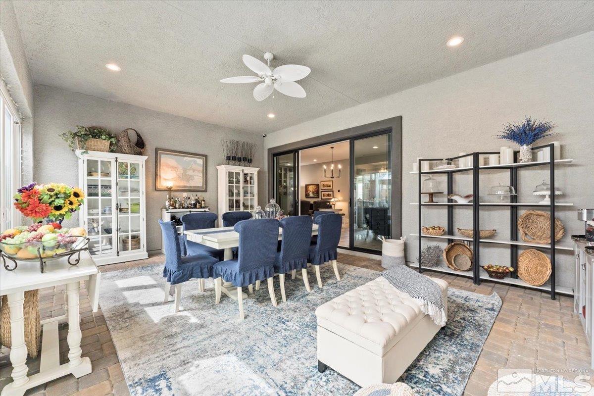 2166 Kate's Bridge Drive Reno, NV 89521 - Photo 14 of 34 a view of a dining room with furniture a rug and wooden floor