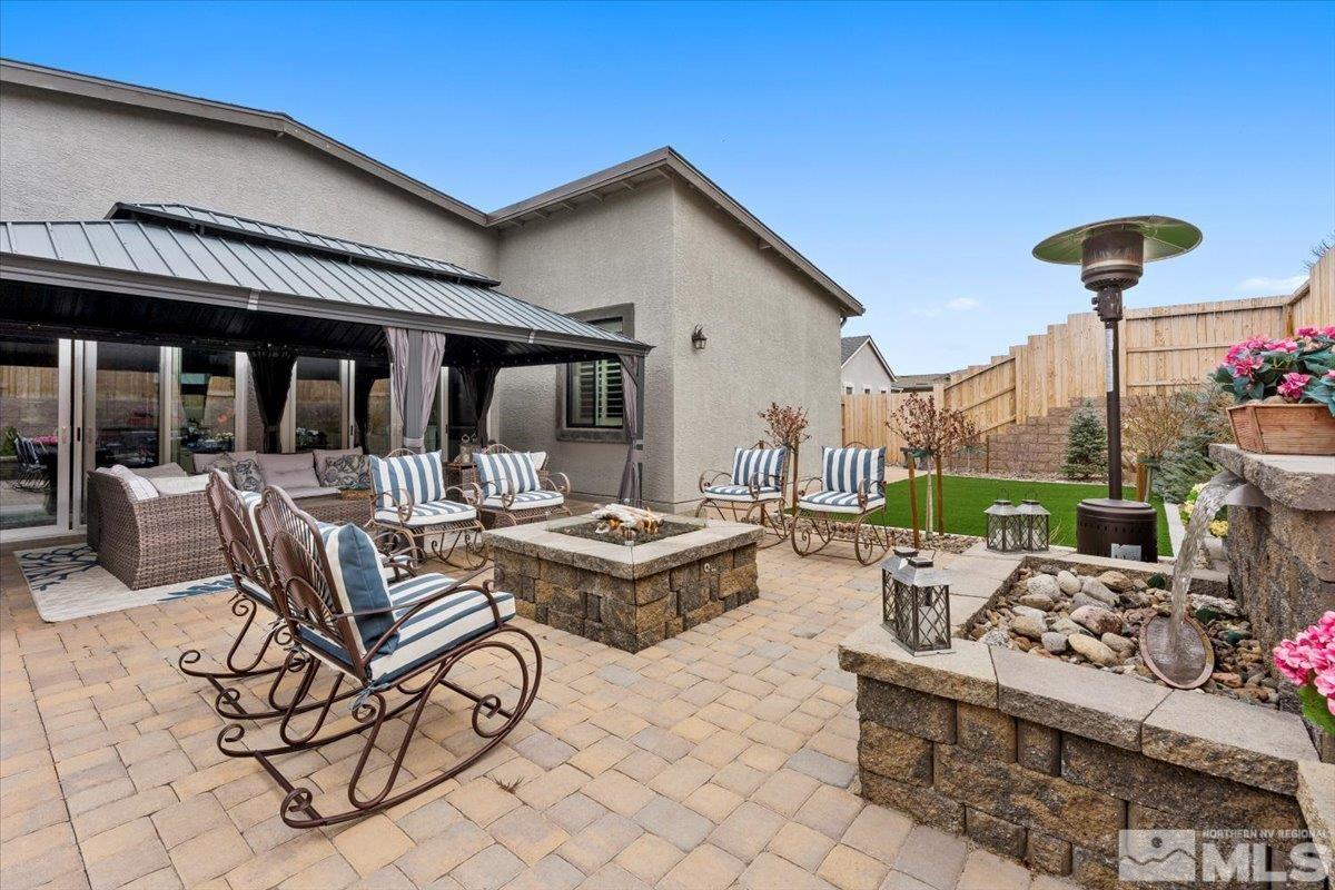 2166 Kate's Bridge Drive Reno, NV 89521 - Photo 26 of 34 a view of a patio with couches table and chairs and potted plants