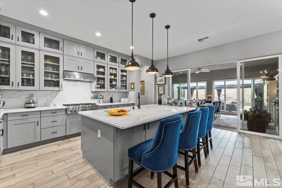 2166 Kate's Bridge Drive Reno, NV 89521 - Photo 3 of 34 a kitchen with a stove a table and chairs