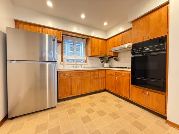 a kitchen with stainless steel appliances a refrigerator sink and cabinets