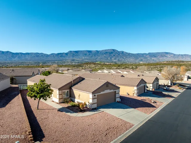 a view of a terrace with a table and chairs under an umbrella