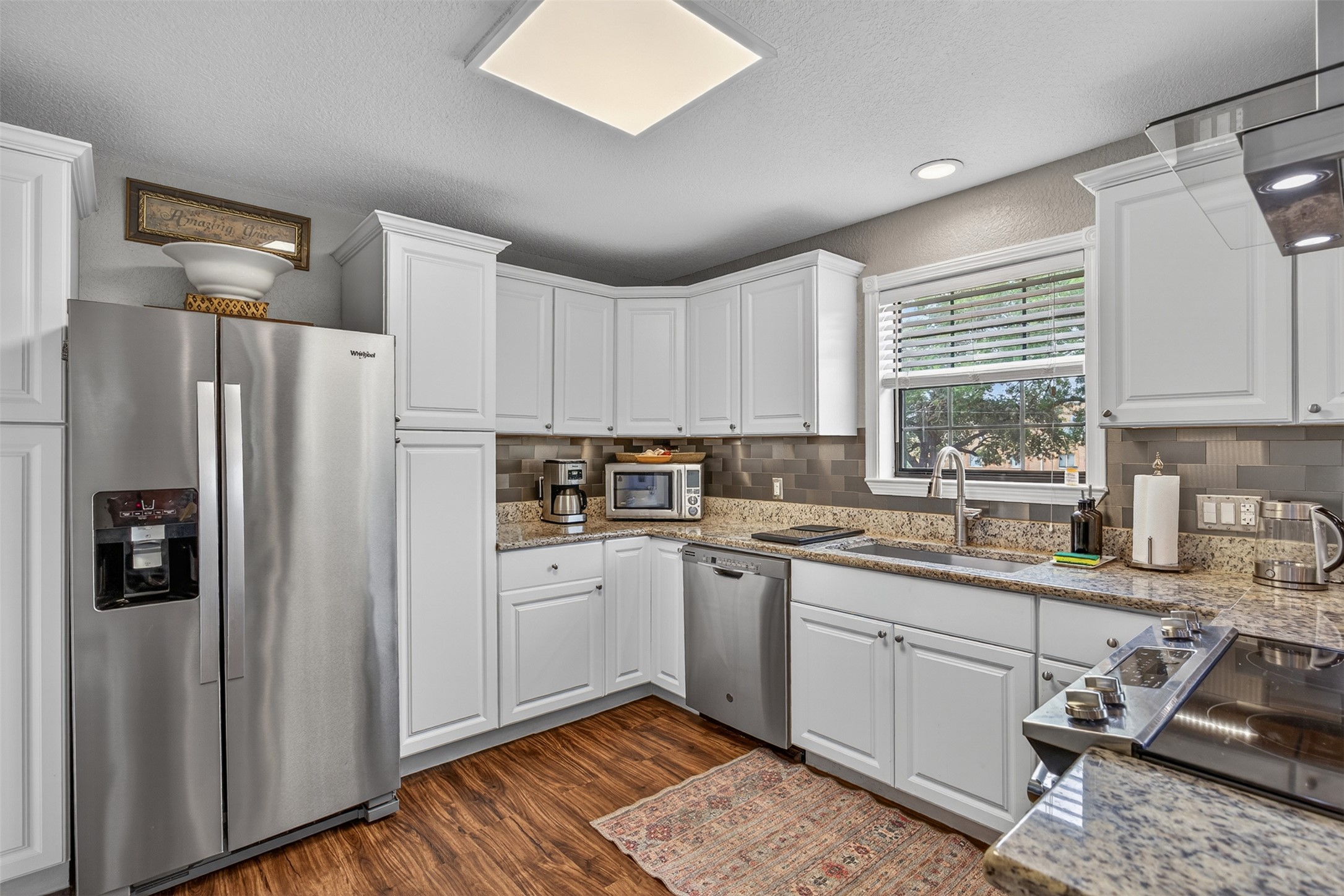 217 Walnut Avenue Luling, TX 78648 - Photo 11 of 38 a kitchen with stainless steel appliances granite countertop a refrigerator sink and stove