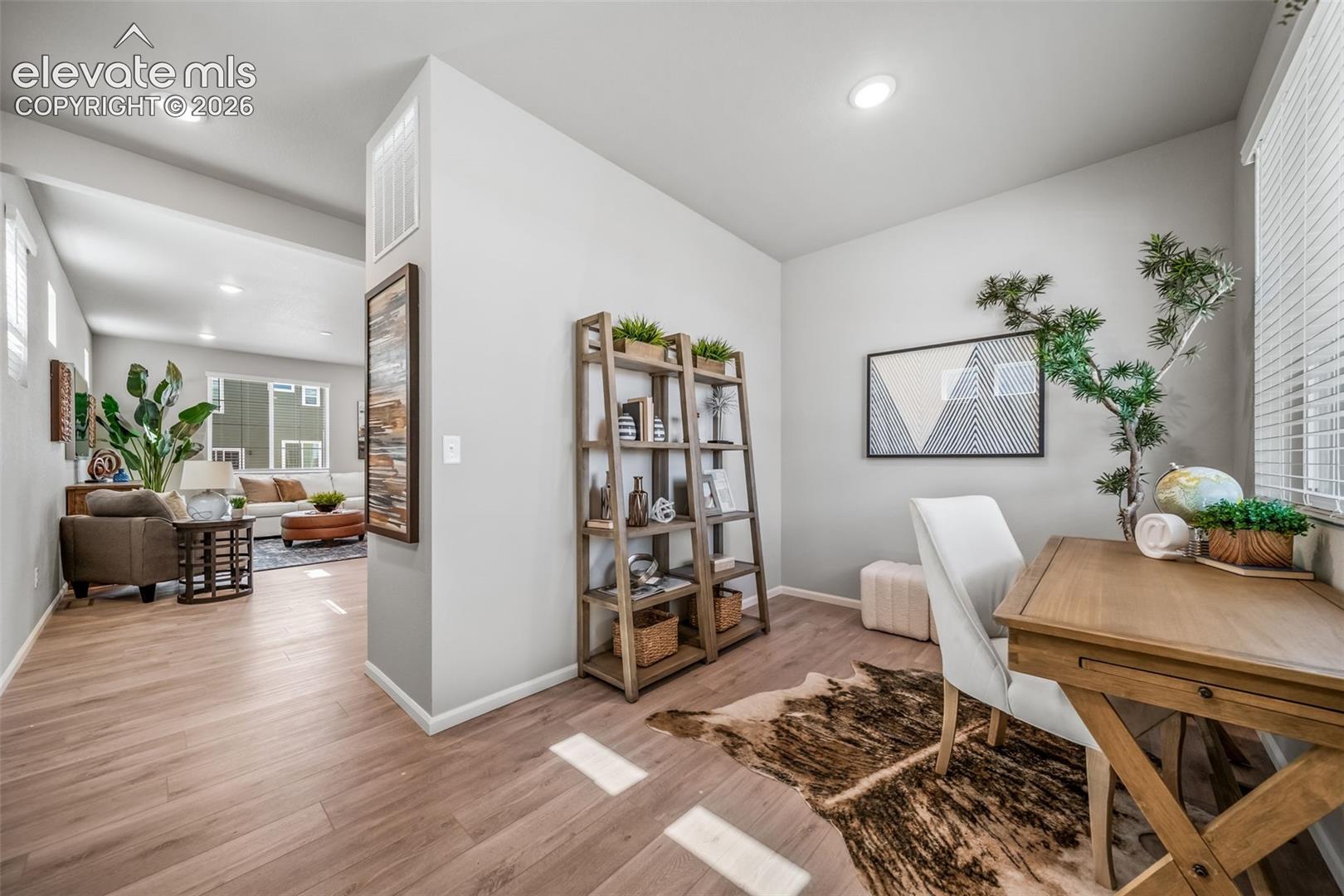4866 Truscott Road Colorado Springs, CO 80925 - Photo 12 of 20 Dedicated work area featuring wood-finish flooring, recessed lighting, and a window with horizontal blinds
*Photos of a model home*
