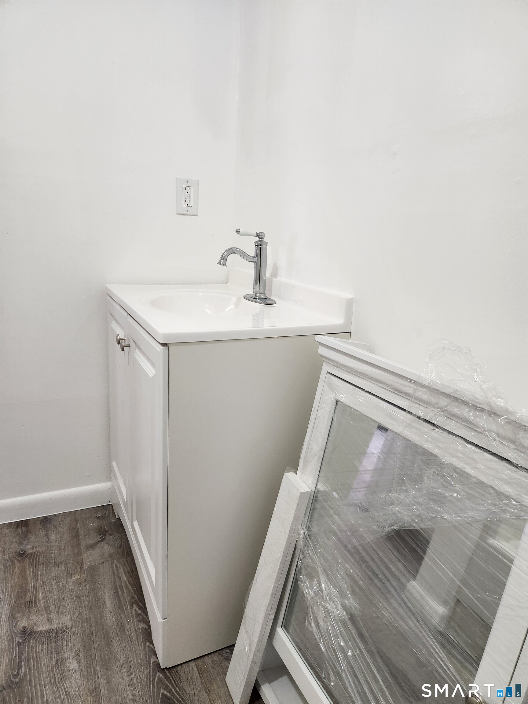 202 Harral Avenue, Unit B Bridgeport, CT 06604 - Photo 6 of 11 a bathroom with a sink and mirror