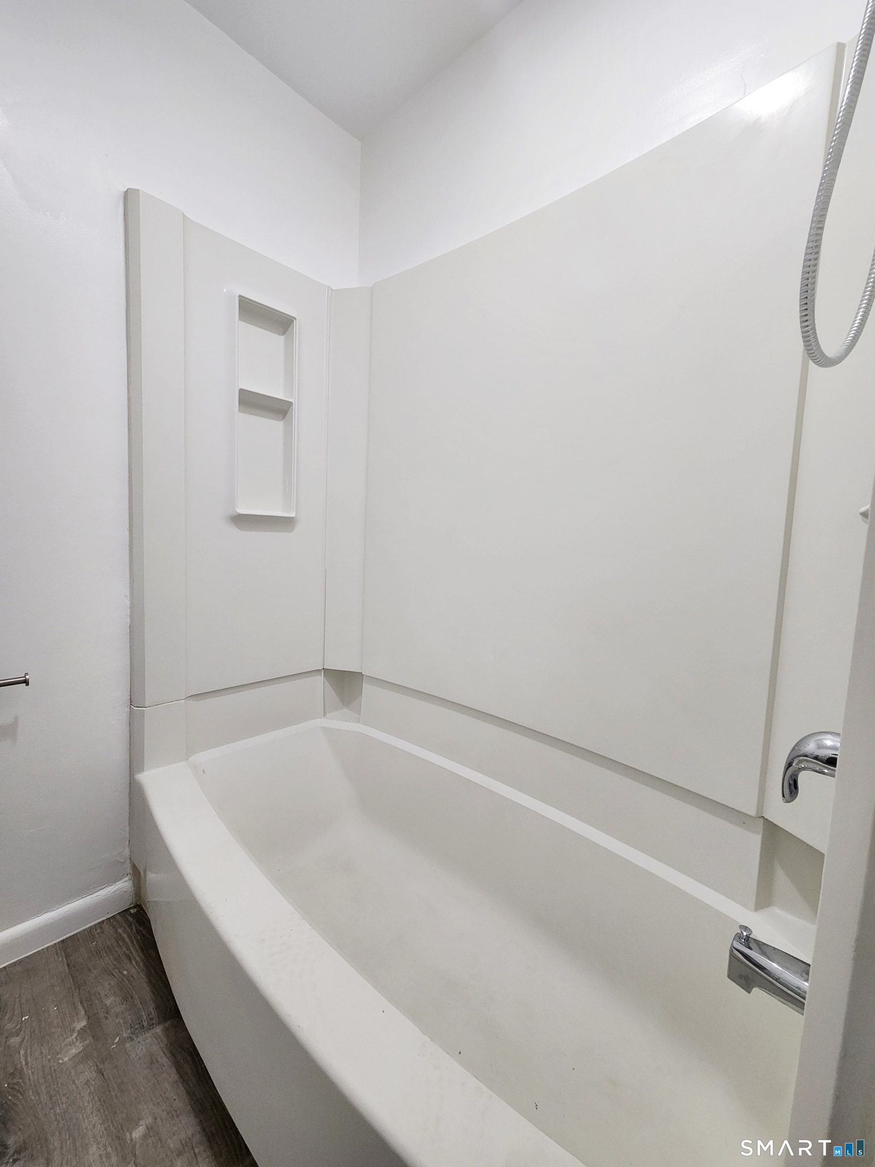 202 Harral Avenue, Unit B Bridgeport, CT 06604 - Photo 7 of 11 a white bath tub sitting next to a shower
