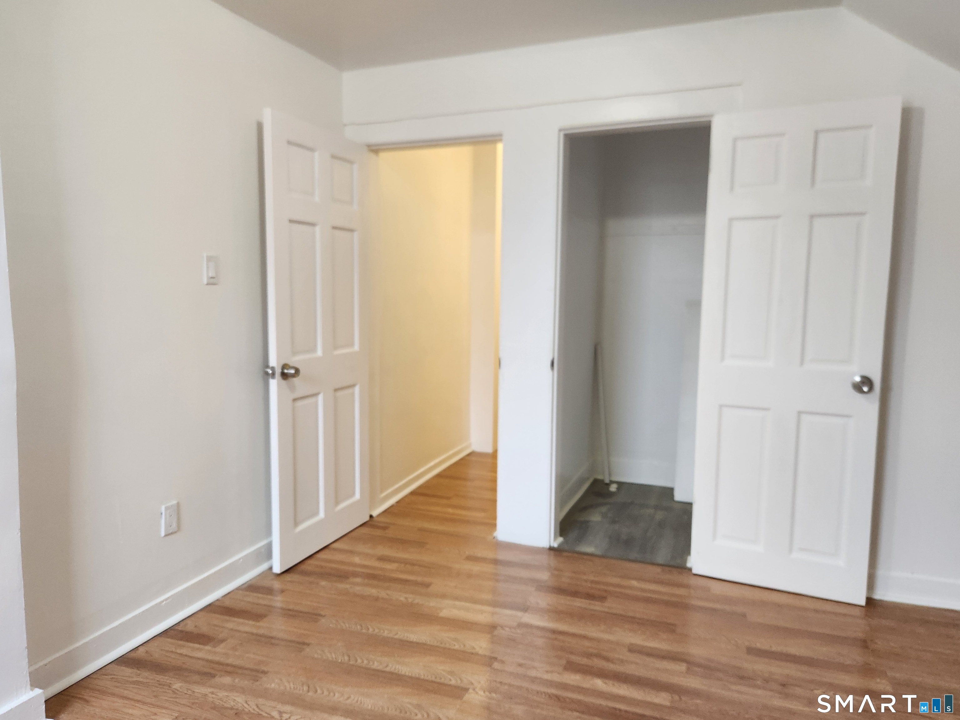 202 Harral Avenue, Unit B Bridgeport, CT 06604 - Photo 9 of 11 an empty room with wooden floor and entrance