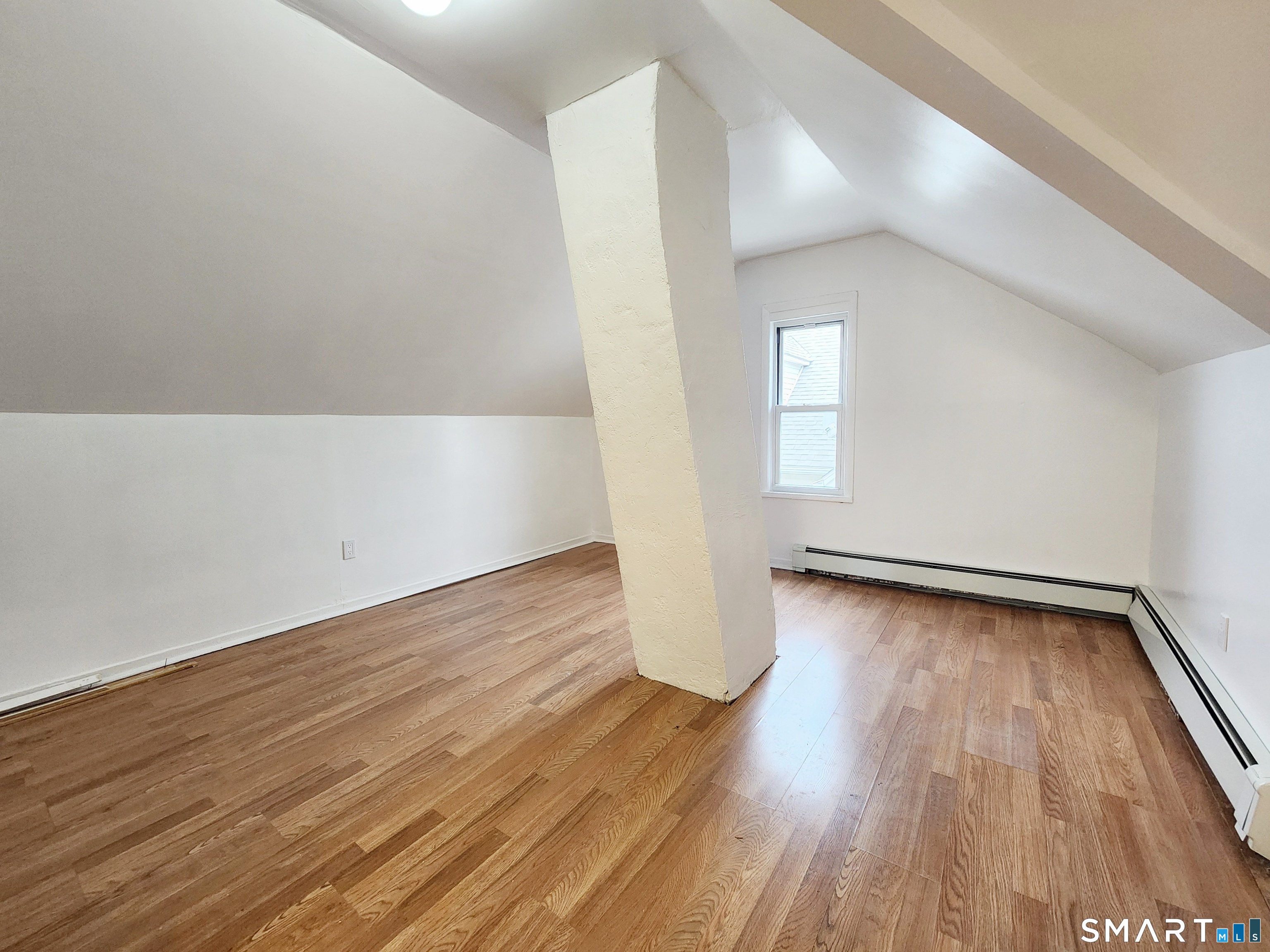 202 Harral Avenue, Unit B Bridgeport, CT 06604 - Photo 10 of 11 a view of a room with wooden floor and window