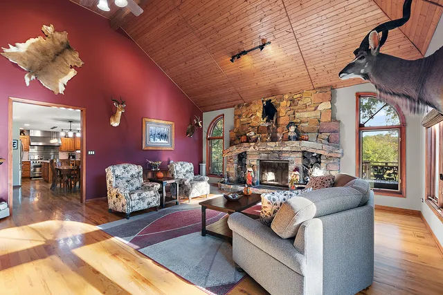 a living room with furniture a chandelier and a large window