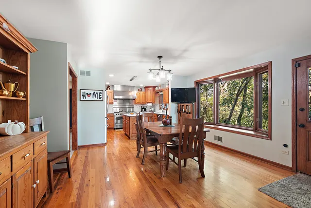 a dining room with furniture and wooden floor