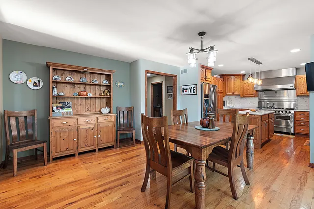 a kitchen with stainless steel appliances granite countertop a sink stove microwave and refrigerator