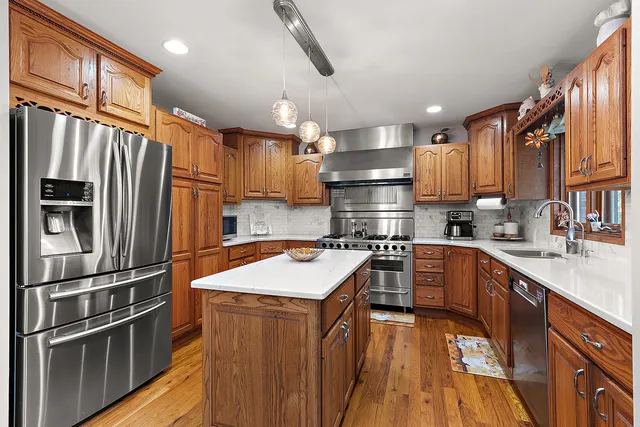 a kitchen with a sink stove and wooden cabinets