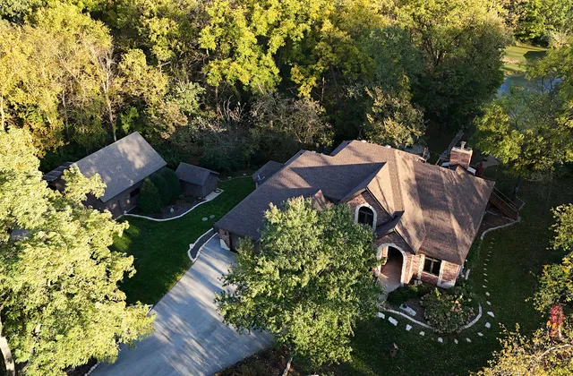 an aerial view of a house with a yard