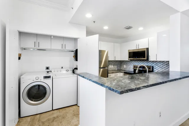 a kitchen with a sink a washer and dryer