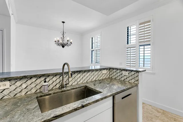 a kitchen with a sink and chandelier
